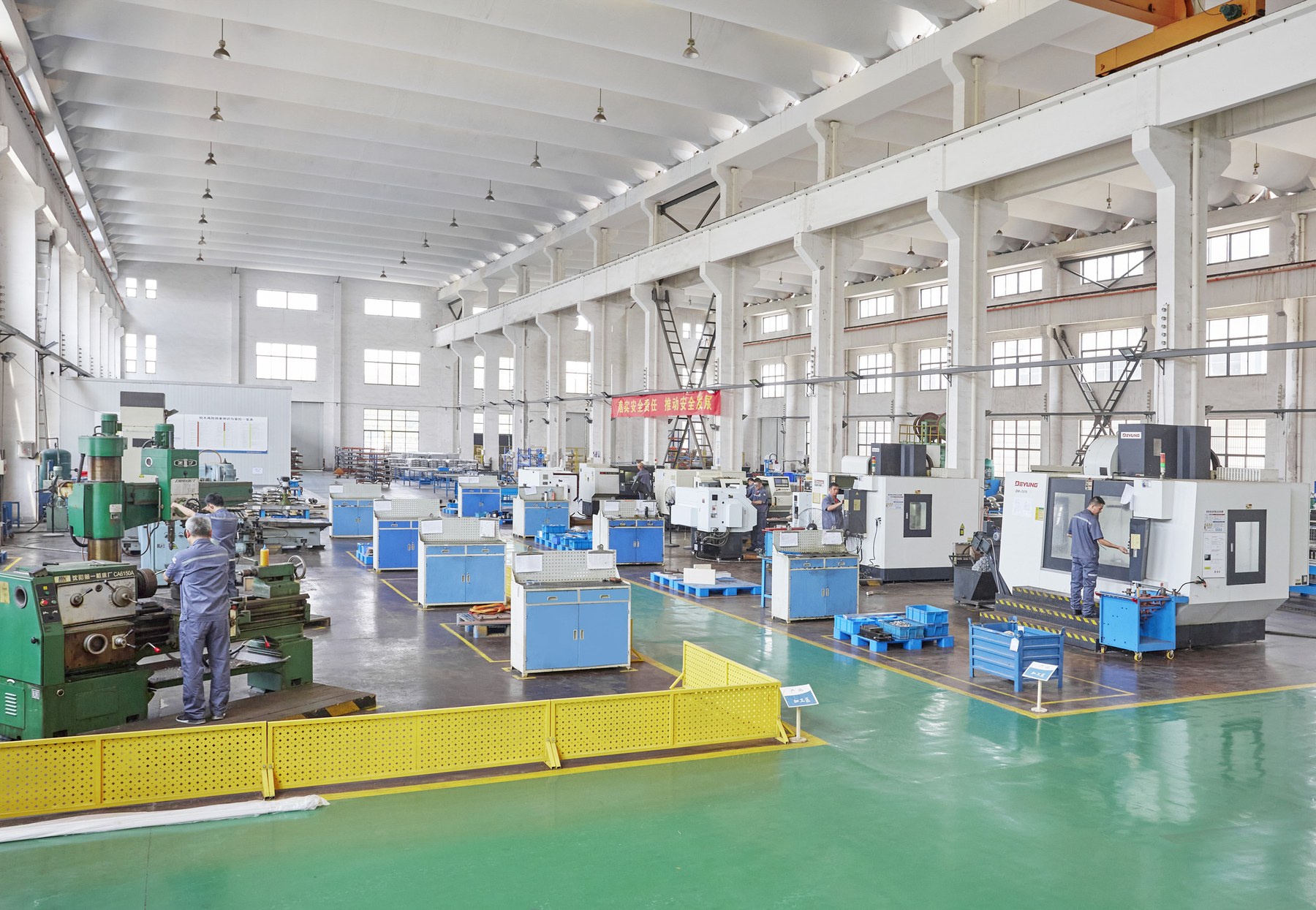 Full view of the machining workshop with a conventional lathe in the foreground